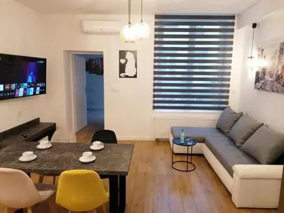 a living room with a couch and a table at Kazimierz Old Town Apartments in Kraków