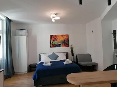 a bedroom with a bed with two towels on it at Kazimierz Old Town Apartments in Kraków