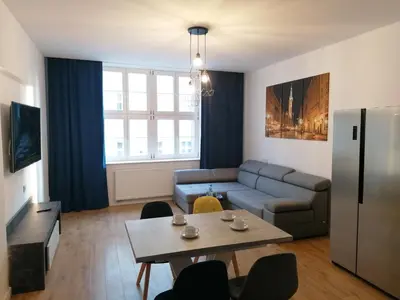 a living room with a couch and a table at Kazimierz Old Town Apartments in Kraków