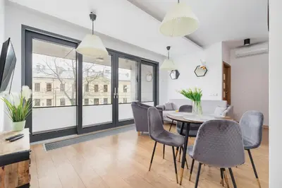 a dining room with a table and chairs at Nadwiślańska 5 Apartments Kraków by Noclegi Renters in Kraków