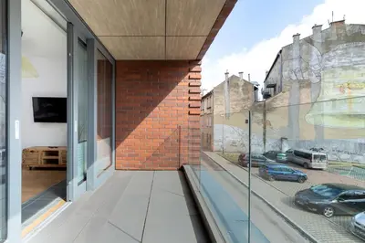 a house with a view of a street from a glass window at Nadwiślańska 5 Apartments Kraków by Noclegi Renters in Kraków