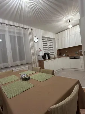 a kitchen with a table and a dining room with a tableablish at Dolce Vita in Mszana Dolna