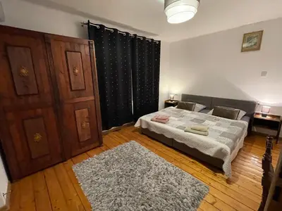 a bedroom with a bed and a black curtain at Dolce Vita in Mszana Dolna