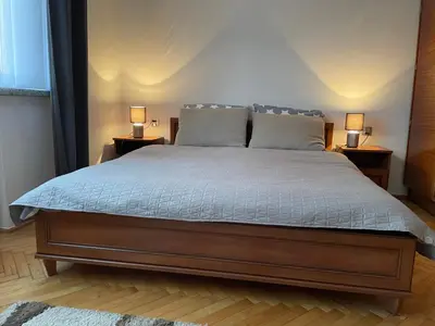 a bedroom with a bed with two lamps on tables at Dolce Vita in Mszana Dolna