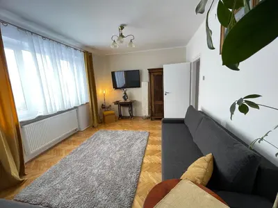 a living room with a couch and a television at Dolce Vita in Mszana Dolna