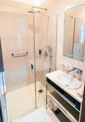 a bathroom with a shower and a sink at Sky Hotel Kraków in Kraków