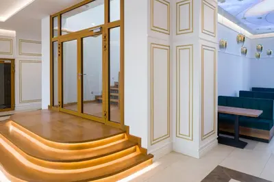 a set of stairs in a lobby with blue chairs at Sky Hotel Kraków in Kraków