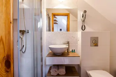 a bathroom with a sink and a shower at Karczma Maciejówka in Czajowice