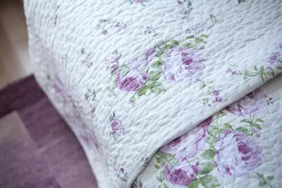 a close up of a mattress with flowers on it at Karczma Maciejówka in Czajowice