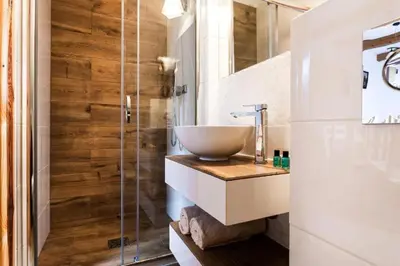 a bathroom with a sink and a glass shower at Karczma Maciejówka in Czajowice