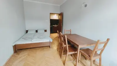 a room with a table and a bed and a table and chairs at Floriańska 10 by Homeprime in Kraków