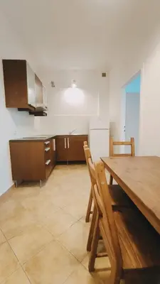 a kitchen with a wooden table and wooden chairs at Floriańska 10 by Homeprime in Kraków