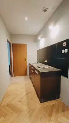 a kitchen with a sink and a wooden floor at Floriańska 10 by Homeprime in Kraków