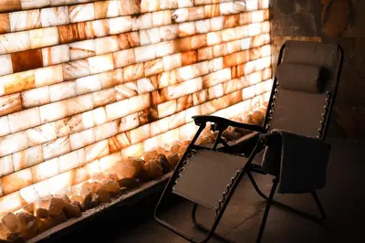 a chair sitting in front of a brick wall at Pensjonat Zdrojowy in Rabka