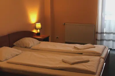 two beds in a hotel room with towels on them at Hotel Kreator-Sport in Kraków