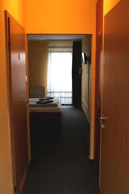 a room with a bedroom with a bed and a window at Hotel Kreator-Sport in Kraków