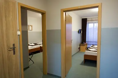 a room with a room with a bed and a mirror at Hotel Kreator-Sport in Kraków