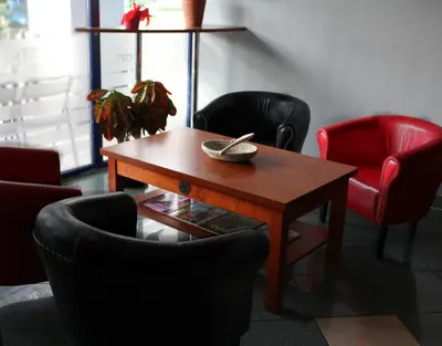 a room with chairs and a wooden table at Hotel Kreator-Sport in Kraków