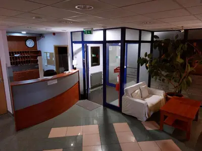 a lobby with a waiting room with a couch and a table at Hotel Kreator-Sport in Kraków