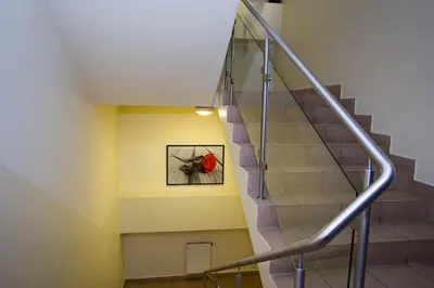 a staircase with a red flower in a picture at Hotel Kreator-Sport in Kraków