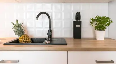a kitchen counter with a sink with a pineapple on it at Finale Apartments in Kraków