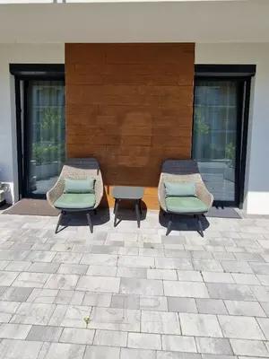 two chairs and a table on a patio at Apartamenty Parkowe B5 in Oświęcim