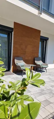 a group of chairs sitting on a patio at Apartamenty Parkowe B5 in Oświęcim