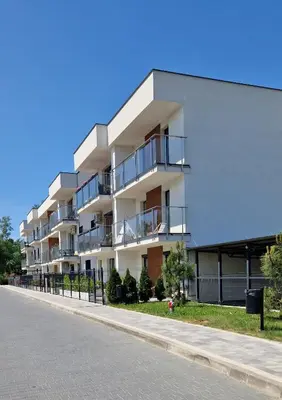 an apartment building with balconies on a street at Apartamenty Parkowe B5 in Oświęcim
