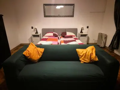 a green couch with yellow pillows in a bedroom at Main Square 18 King Apartament in Kraków