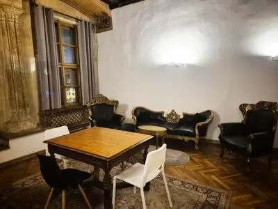 a table and chairs in a room with a table and chairs at Main Square 18 King Apartament in Kraków