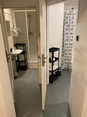 a bathroom with a shower and a sink and a mirror at Main Square 18 King Apartament in Kraków