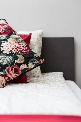 a bed with two pillows on top of it at Dluga Apartments in Kraków
