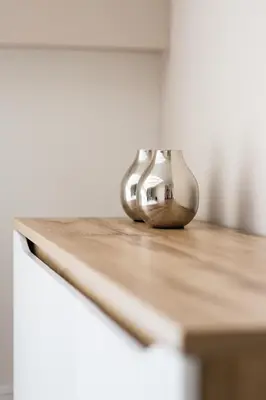 a metal object sitting on top of a wooden table at Dluga Apartments in Kraków