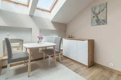 a dining room with a table and two chairs at Dluga Apartments in Kraków
