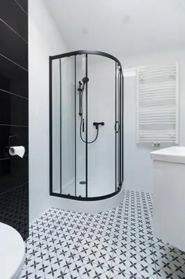 a bathroom with a shower with a glass door at Dluga Apartments in Kraków