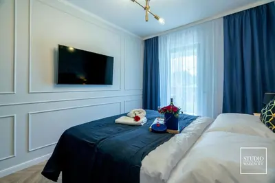 a bedroom with a bed with two stuffed animals on it at Exclusive Gold Apartment in Kraków