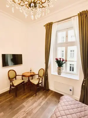 a dining room with a table and a window at Kochanowskiego Apartment - Topolove Rooms & Apartments in Kraków