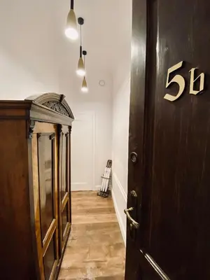 a hallway with a sign on the door at Kochanowskiego Apartment - Topolove Rooms & Apartments in Kraków