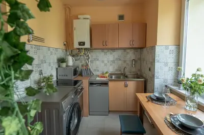 a small kitchen with a sink and a dishwasher at Apartament Premium Salt in Wieliczka