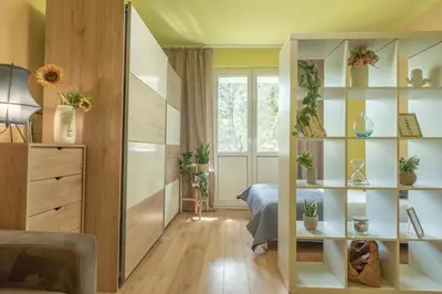 a bedroom with a bed and a book shelf at Apartament Premium Salt in Wieliczka
