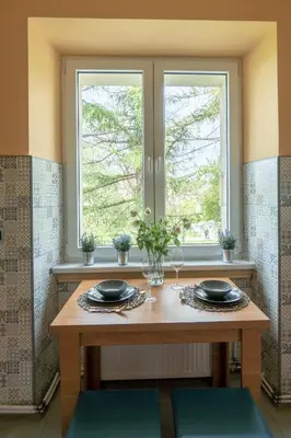 a table in a room with a window at Apartament Premium Salt in Wieliczka