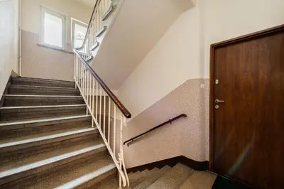 a staircase in a building with a wooden door at Apartament Premium Salt in Wieliczka