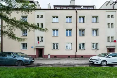 two cars parked in front of a building at Apartament Premium Salt in Wieliczka