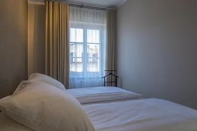 a bed in a bedroom with a window at Na Skałce Apartment in Kraków