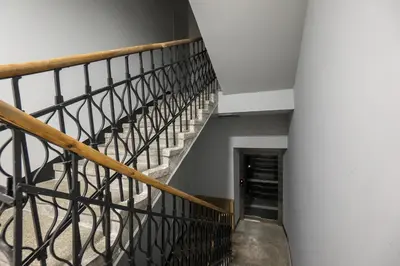a spiral staircase in a building with a hallway at Na Skałce Apartment in Kraków