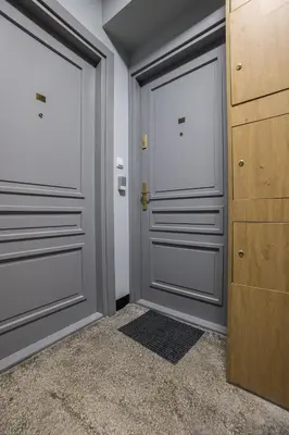 a hallway with two doors and a rug at Na Skałce Apartment in Kraków