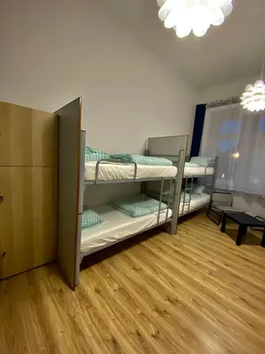 a room with three bunk beds in a room at SKY HOSTEL in Kraków