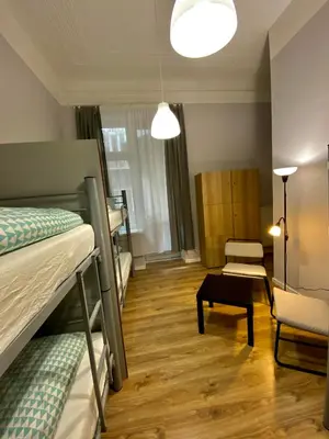 a room with two bunk beds and a chair at SKY HOSTEL in Kraków