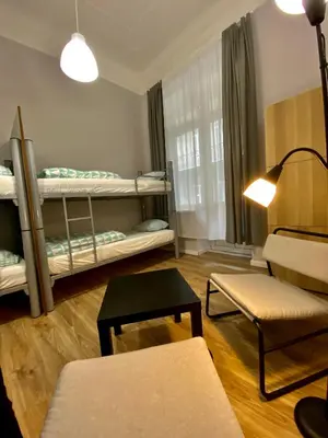 a living room with two bunk beds and a table at SKY HOSTEL in Kraków
