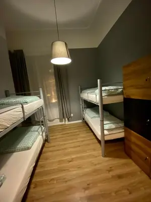 a room with two bunk beds and a lamp at SKY HOSTEL in Kraków